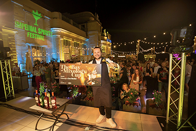 Photo of a bartender triumphantly holding the The Bay of Mixology Cup, celebrating his victory at the Imperial Spirits Festival in Opatija, Croatia.